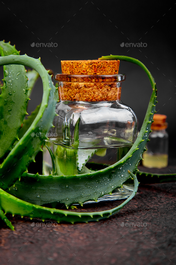 Aloe vera oil in glass bottle and towel for spa - Stock Photo - Images