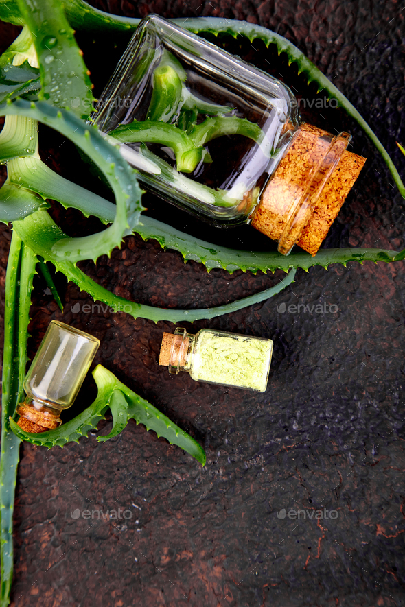 Aloe vera oil in glass bottle and towel for spa - Stock Photo - Images