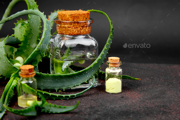 Aloe vera oil in glass bottle and towel for spa - Stock Photo - Images