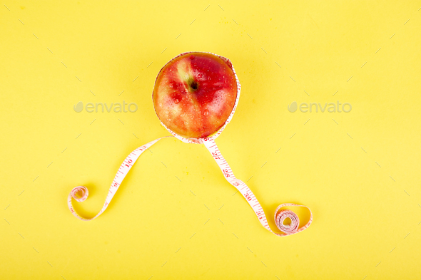 Measuring tape wrapped around a red apple - Stock Photo - Images