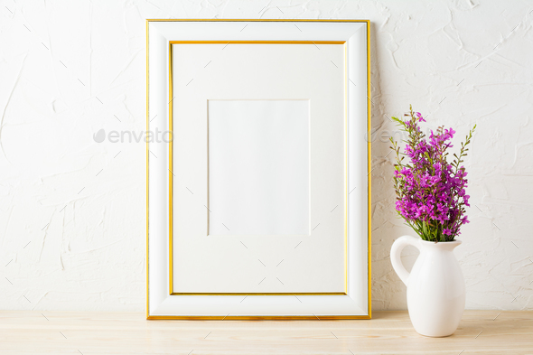 Gold decorated frame mockup and purple wildflowers in pitcher Stock Photo by TasiPas