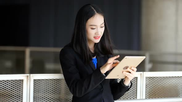 Asian girl holding a tablet shopping online