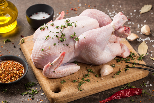 Fresh raw chicken on cutting board and spices for cooking Stock Photo by  ff-photo