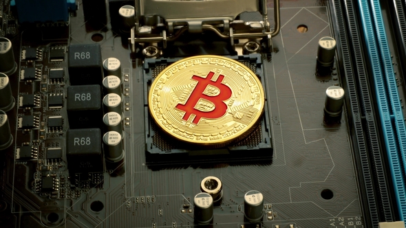 Gold Bit Coin BTC Coins on the Motherboard. Bitcoin Is a Worldwide Cryptocurrency alt