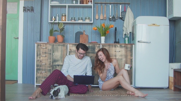 Couple in Love and Their Dog Hugging and Using Tablet Together.