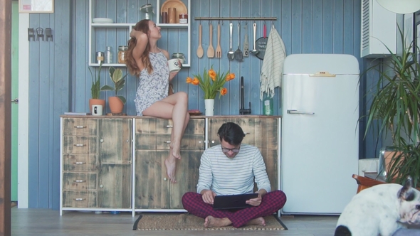 Couple in Love and Their Dog Hugging and Using Tablet Together