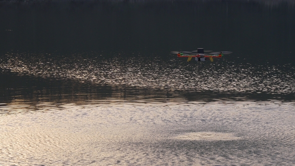 Drone Above the Water Creates Ripples on the Water By Propellers
