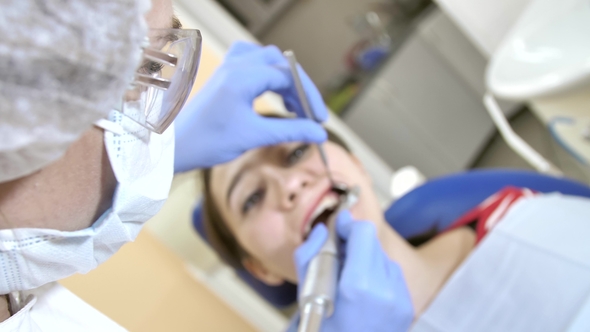 Dentist's in Medical Glasses Treat Patient. Point of View Ortodont