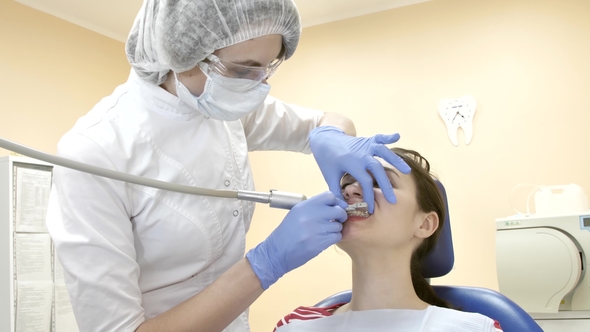 Dentist at Work in the Office. Female Doctor Stomatologist During Treats Teeth