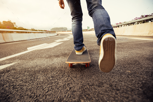 Skateboarding legs on highway