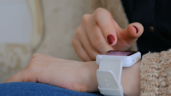 Woman Using Smart Watch at Home