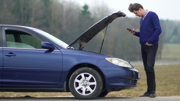 The Man Broke the Car. Uses a Mobile Phone