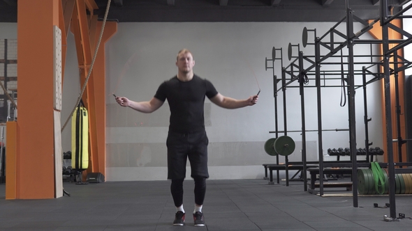 Fitness Man Doing Double Jumps Rope Exercise in Gym