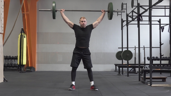 Fitness Man Doing Barbell Snatch Exercise in Gym