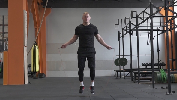 Fitness Man Doing Double Jumps Rope in the Gym