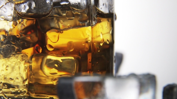 Whiskey in a Glass with Ice on a Light Background