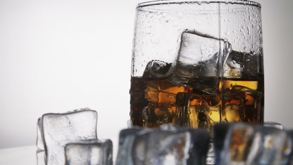 Whiskey in a Glass with Ice on a Light Background