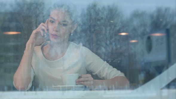 Upset Female Having Angry Phone Conversation While Sitting in a Cafe alt