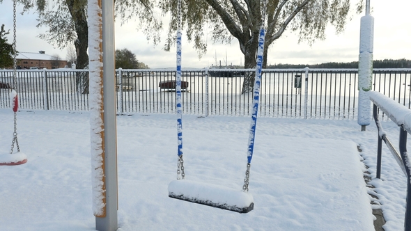 Swing Sets on Children Playground Covered With Snow, Abandoned Children Playground on Winter