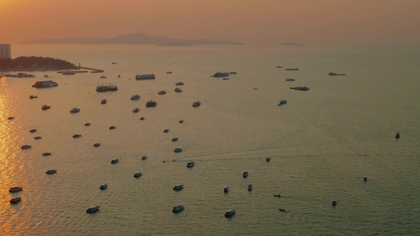 Up View of Boats and Ship in Pattaya Bay in Sunbeams During Picturasque Sunset