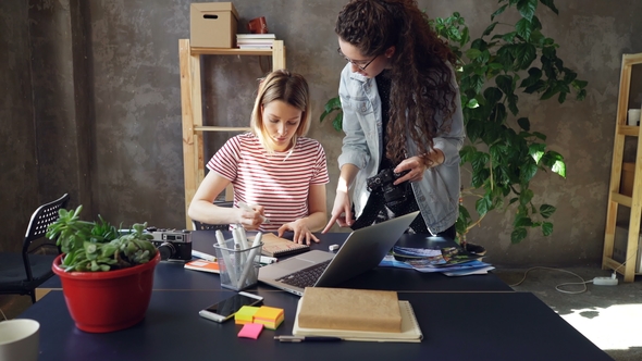 Young Creative Colleagues Are Planning Design, Drawing Layout in Notebook and Watching Photos alt