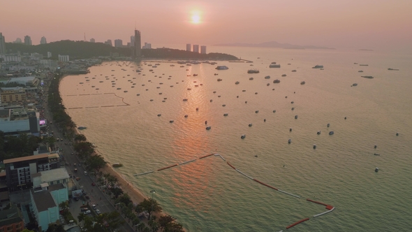 Up View of Boats and Ship in Pattaya Bay in Sunbeams During Picturasque Sunset