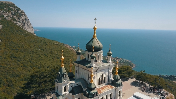 Orthodox Church on a Steep Cliff. Sea and Mountains on a Background. Aerial View of Foros Church on alt