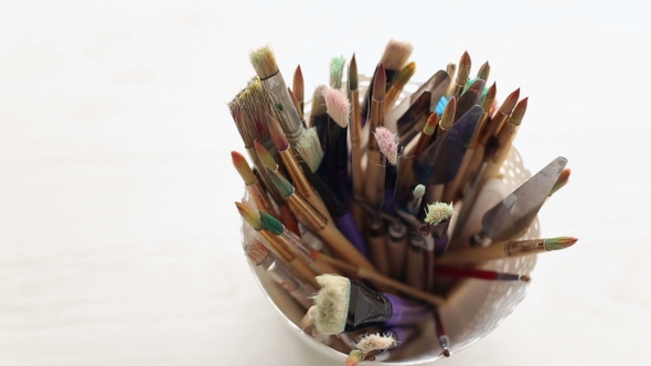 A Set of Brushes for Painting in a Plastic Cup alt