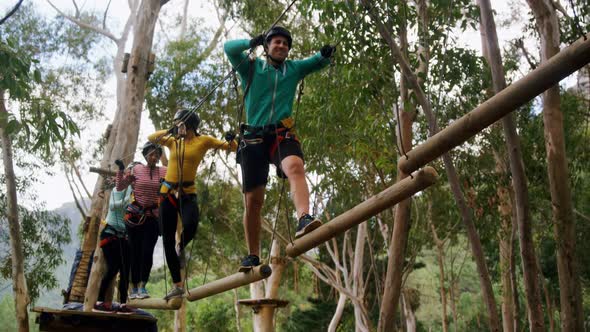 Group of woman and trainer walking on the logs 4k alt