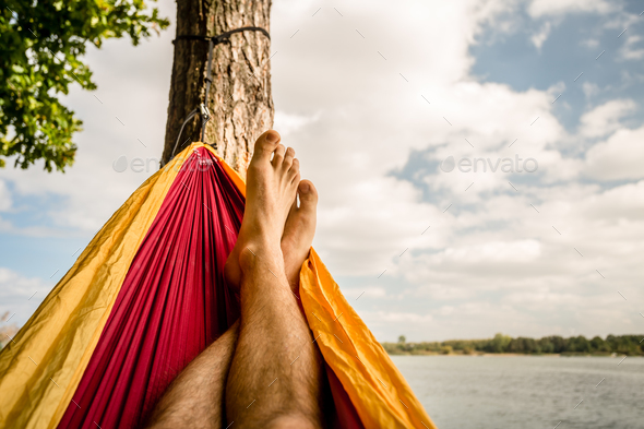 Relaxing in the hammock at the beach under trees, summer day Stock Photo by blas