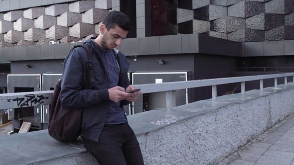 Young Handsome Arabic Man Using Smartphone in City