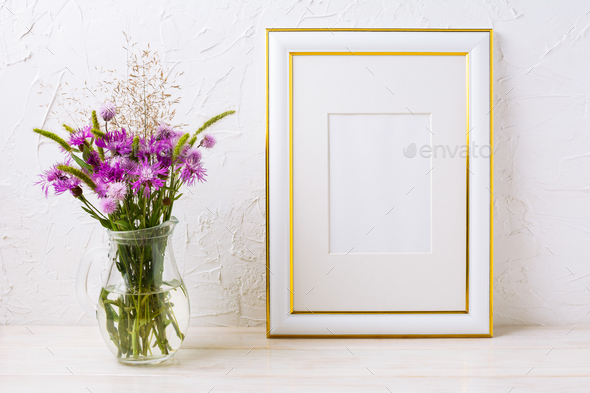 Gold decorated frame mockup with purple burdocks in glass - Stock Photo - Images