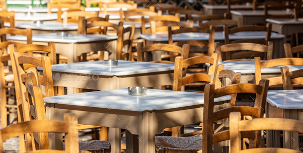 Athens, Greece. Greek tavern empty tables and chairs at Plaka. Stock Photo by rawf8