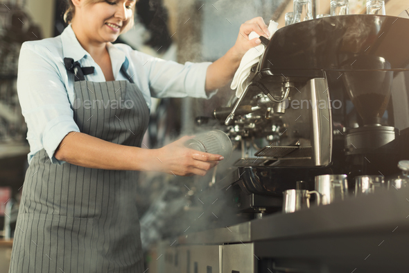 Experienced barista making coffee in professional coffee machine Stock Photo by Milkosx