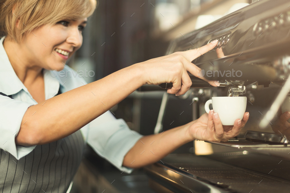 Experienced barista making coffee in professional coffee machine Stock Photo by Milkosx