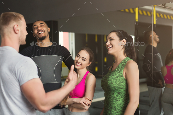 Group of sporty people talking at gym Stock Photo by Milkosx | PhotoDune