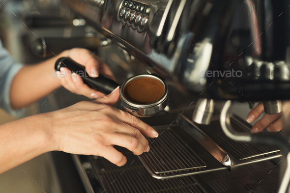 Closeup of barmen hand brewing espresso in professional coffee machine Stock Photo by Milkosx