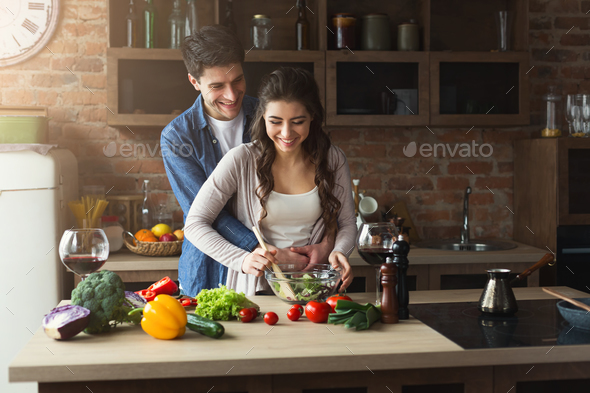 Happy couple cooking healthy food together Stock Photo by Milkosx | PhotoDune