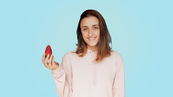 Healthy Young Woman Bites Tasty Red Strawberry