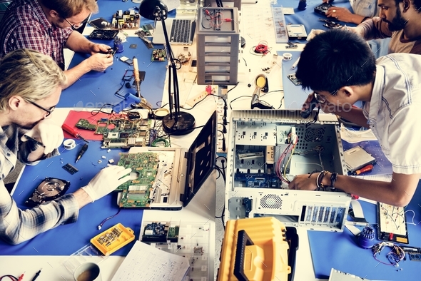 Electronics technicians team working on computer parts
