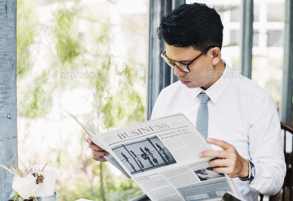 Businessman reading newspaper in the morning Stock Photo by Rawpixel
