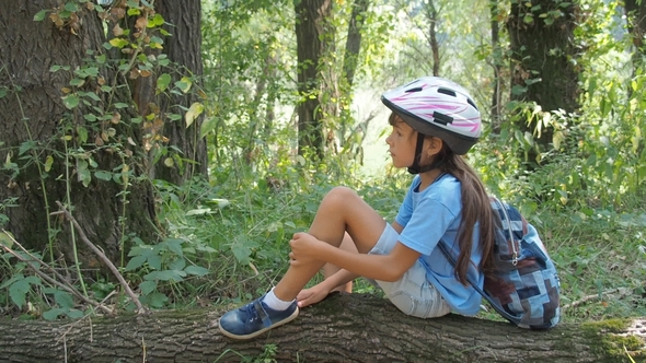 Child in Nature. The Tired Cyclist Rests on the Nature alt