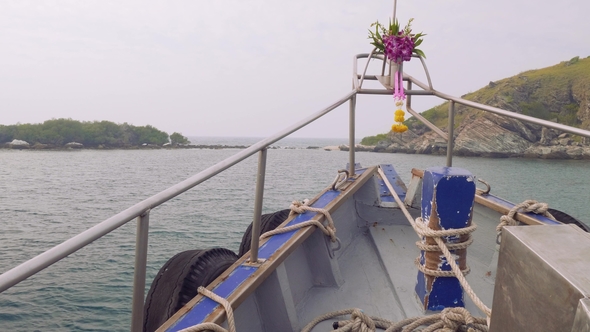 Viewi of Cliffy Shore of Island Rin, Thailand. View From Sailing Boat with Hibiscus on Stempost