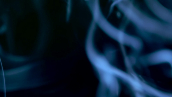 Smoke Slowly Floating Through Space Against Black Background alt