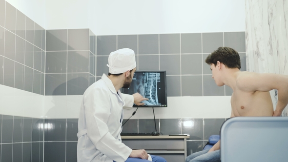 The Doctor Examines the Spine with the Patient