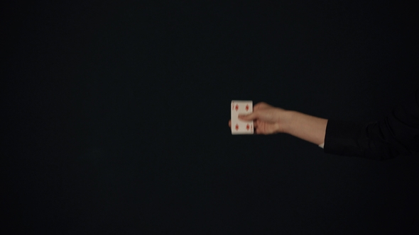 Young Man Showing Tricks with Cards in the Dark