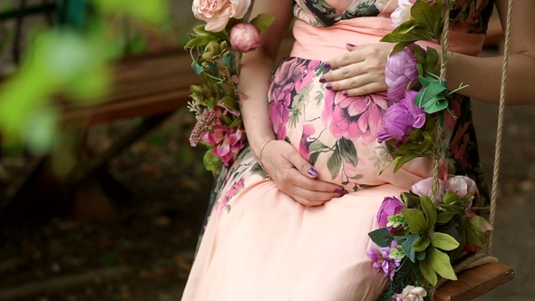 Pregnant Girl in Dress Strokes Her Belly, alt