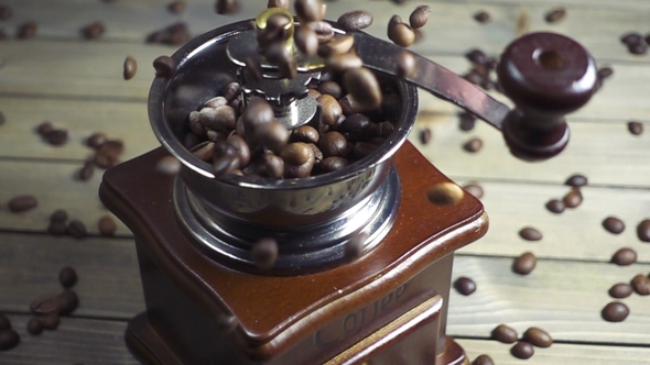 Pouring Coffee Beans Into Wooden Vintage Grinder,