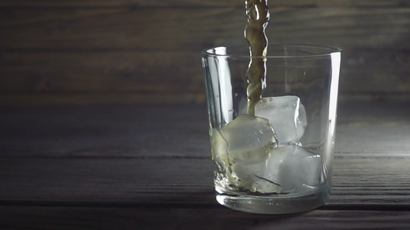 Whisky Is Poured Into Glass in