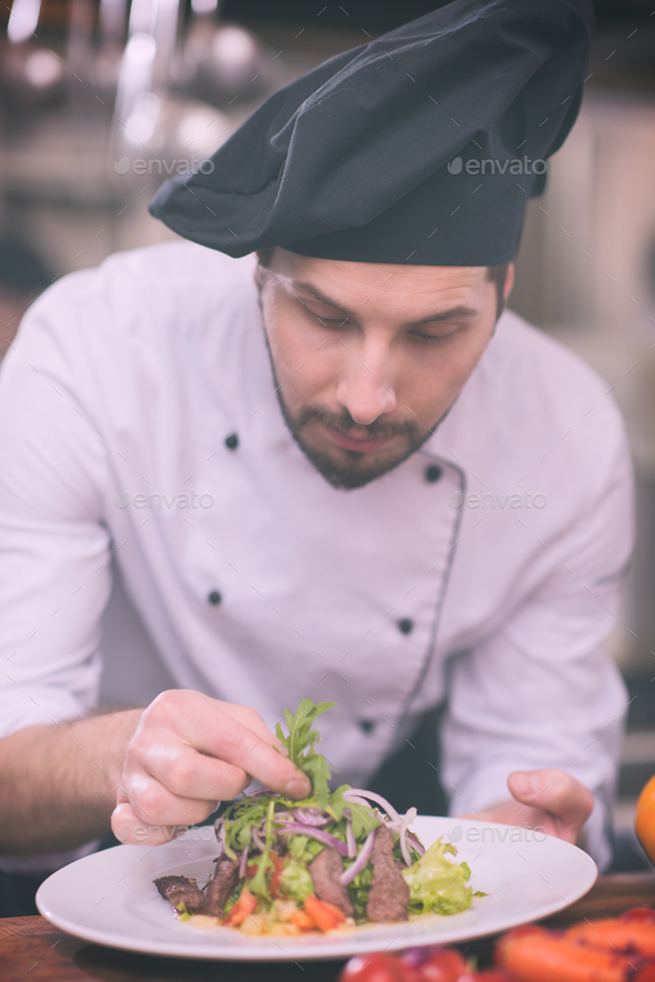 cook chef decorating garnishing prepared meal Stock Photo by dotshock